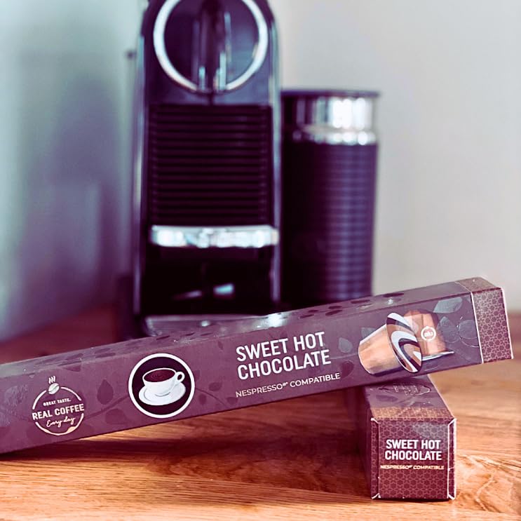 REAL COFFEE GREAT TASTE box next to a hand for size and quantity reference
