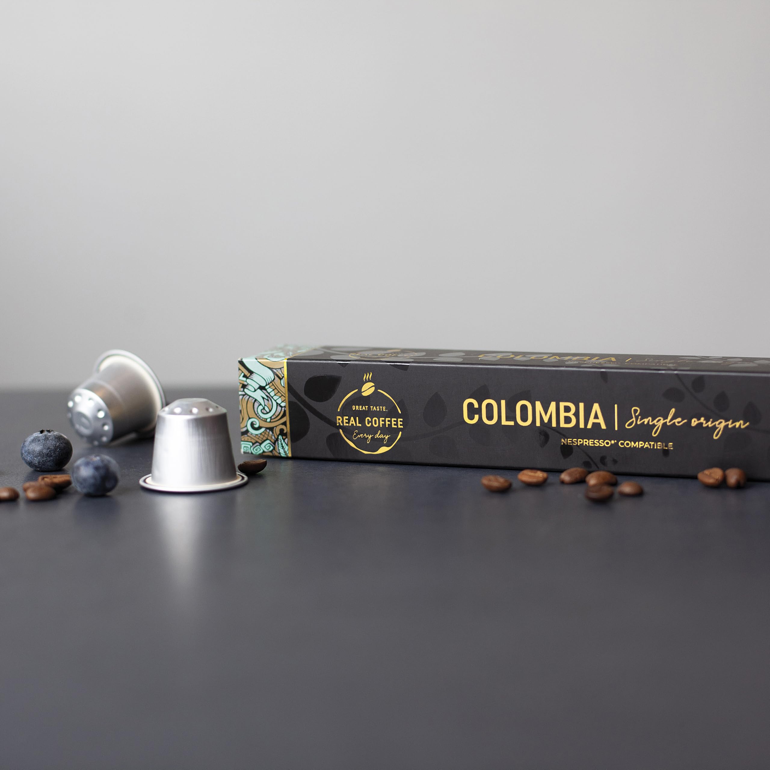 REAL COFFEE GREAT TASTE capsules in hand for scale and easy portioning benefit