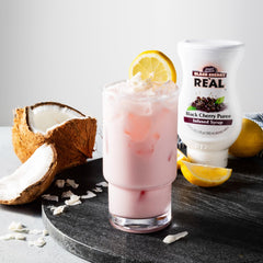 Reàl Infused Exotics pouring into sparkling water to show vibrant color and quick mixing