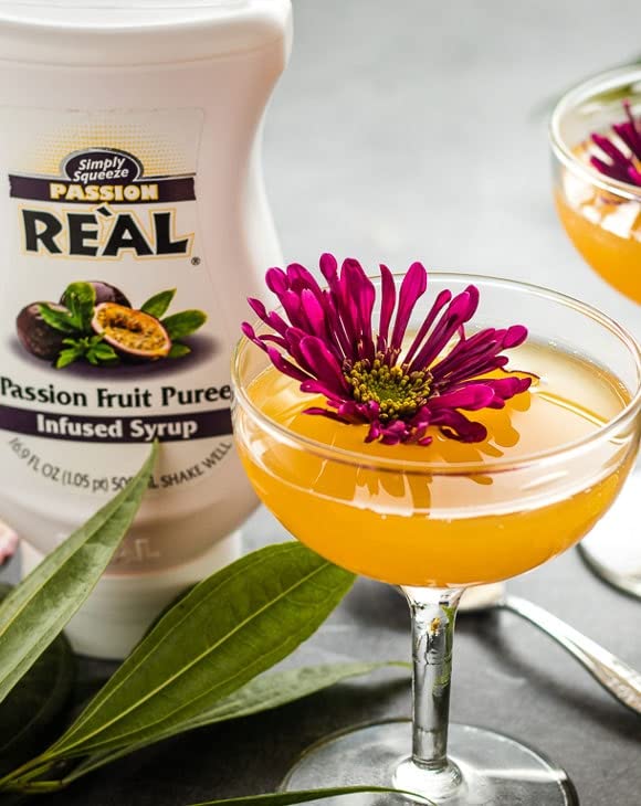Reàl Infused Exotics dragon fruit bottle close-up highlighting puree texture and vibrant color