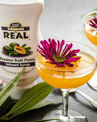 Reàl Infused Exotics dragon fruit bottle close-up highlighting puree texture and vibrant color