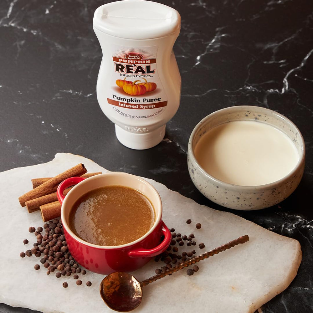 Reàl Infused Exotics poured into a latte illustrating creamy integration and aroma