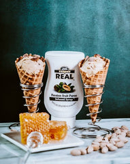Reàl Infused Exotics puree texture pouring from bottle showing smooth blendability benefit