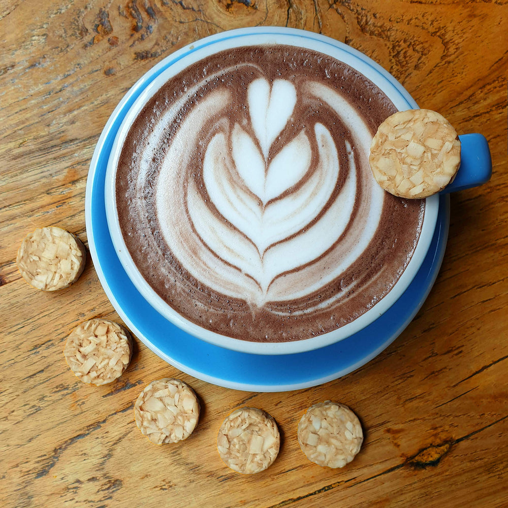 Real Naturals cookies with coffee in lifestyle scene showing convenient snack benefit