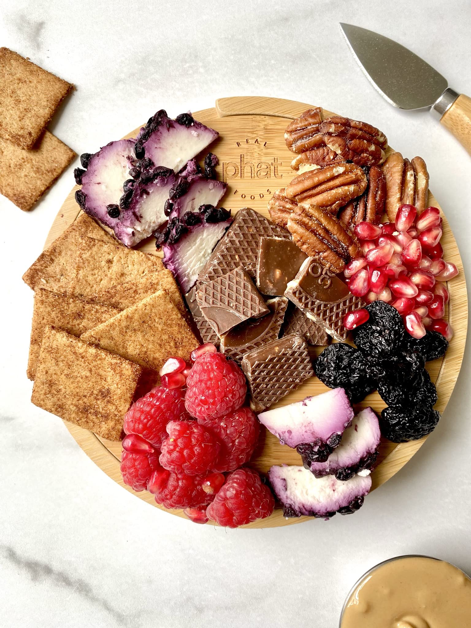 Real Phat Foods stacked crackers next to a dip showing pairing ideas and flavor versatility