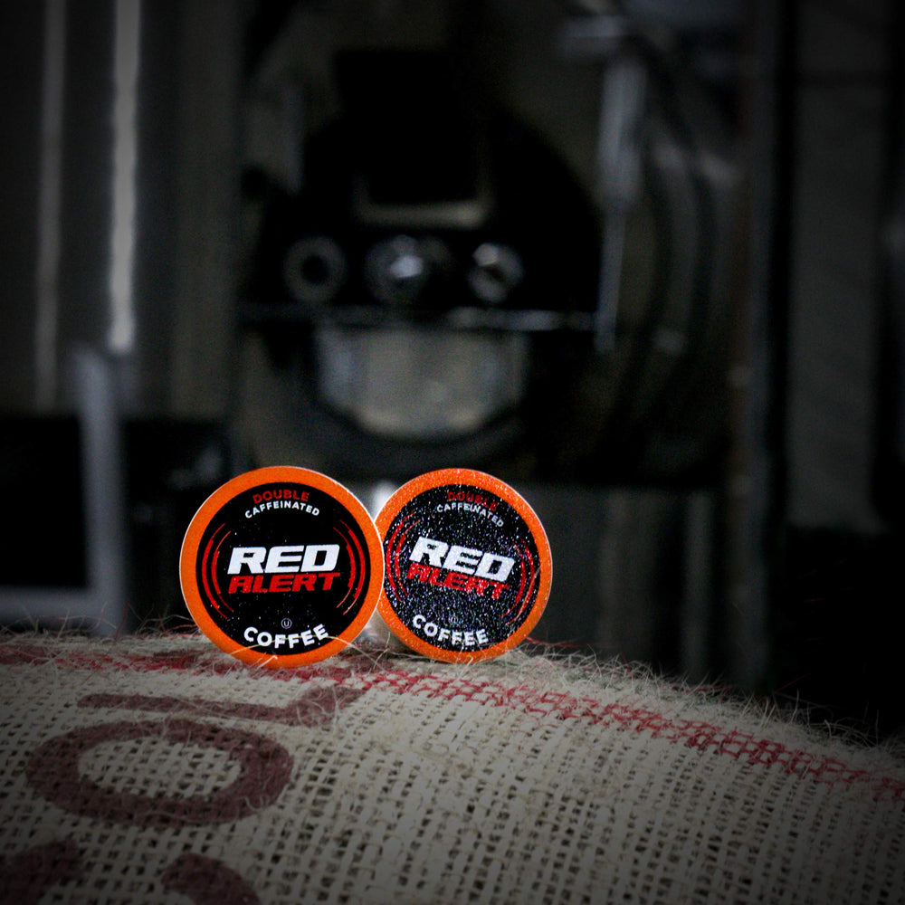 Red Alert mug on a desk morning setup showing energy boost and productivity