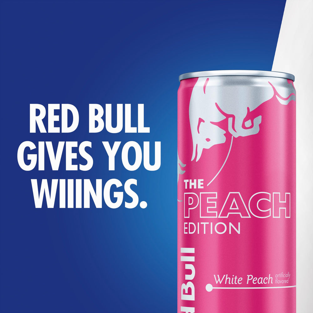 Recycled aluminum cans with Red Bull White Peach label promoting recyclability