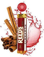 Hand holding a single Reed's cinnamon piece showing portable size and quick flavor benefit