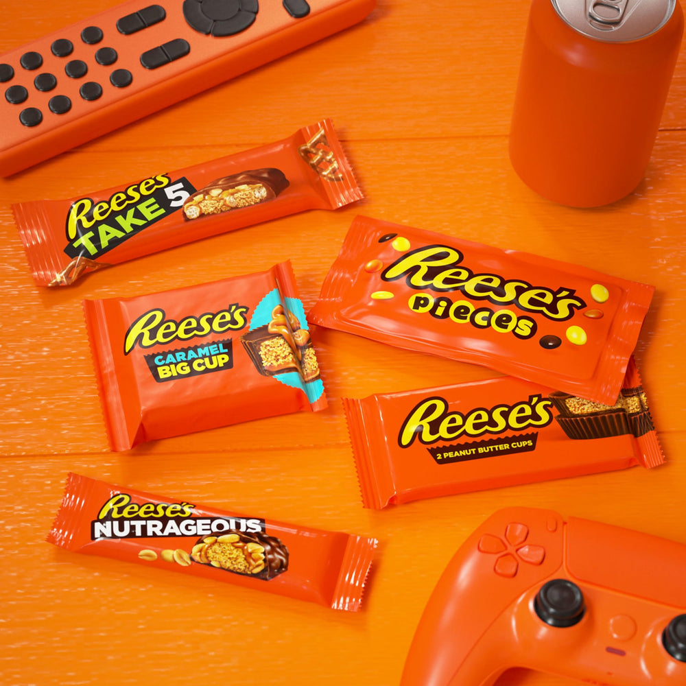 Reese's PIECES scattered showing candy shell pieces and portable snacking benefit
