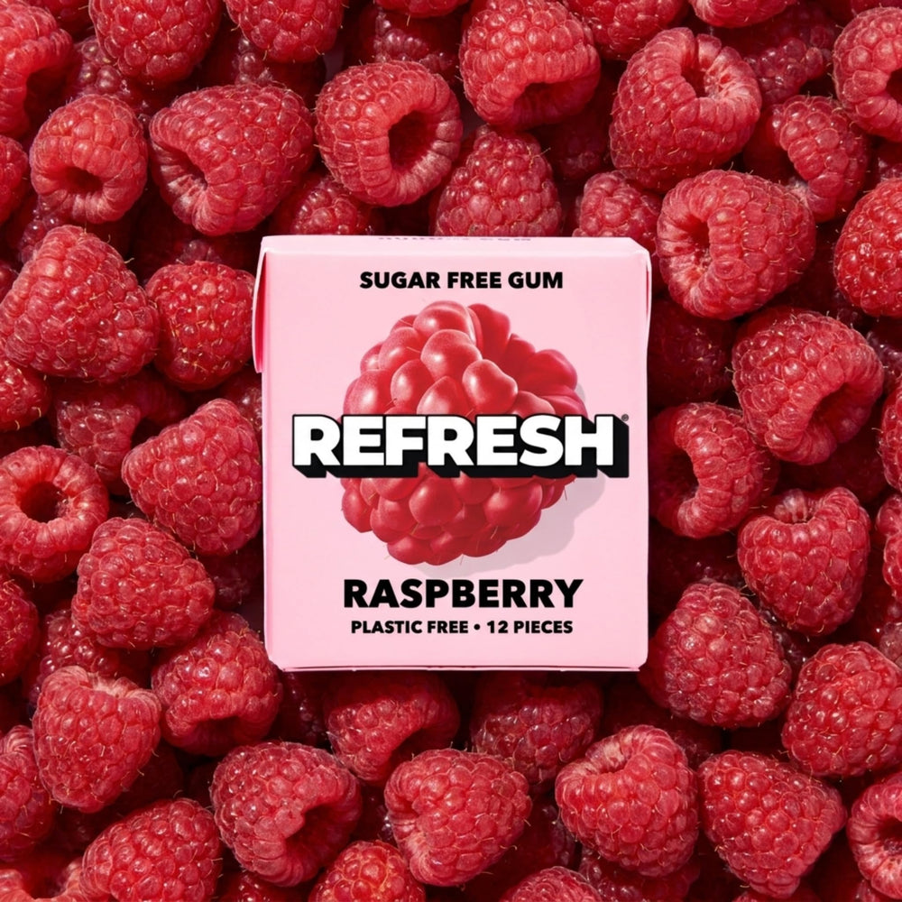 Person chewing Refresh raspberry outdoors enjoying natural fruit flavor