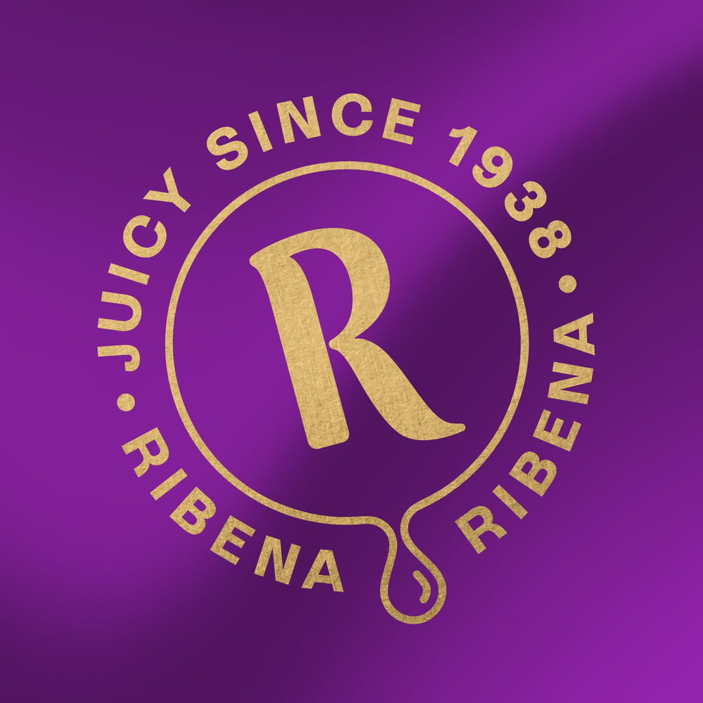 Ribena bottle next to fresh British blackcurrants showing authentic sourcing