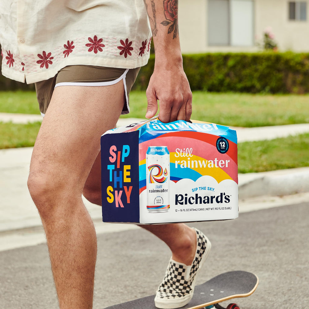 Richard's Rainwater can held in hand showing 16 fl oz scale and portability benefit
