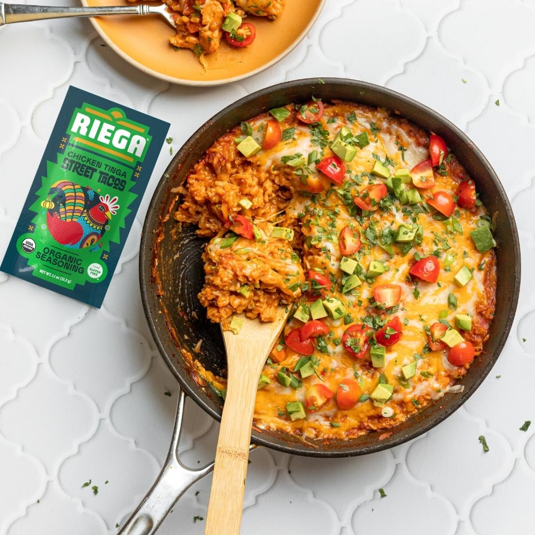 Riega packet held in hand to show portion size for seasoning 2 lbs of chicken