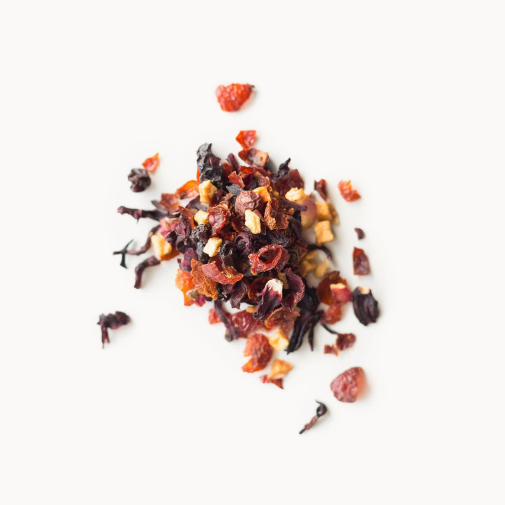 Rishi Tea spoon with measured loose leaf beside scale for accurate brewing