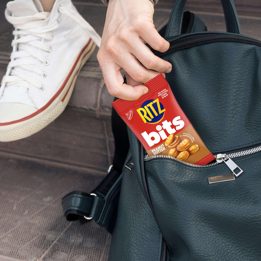 RITZ cracker held in hand to show the bite-sized portion