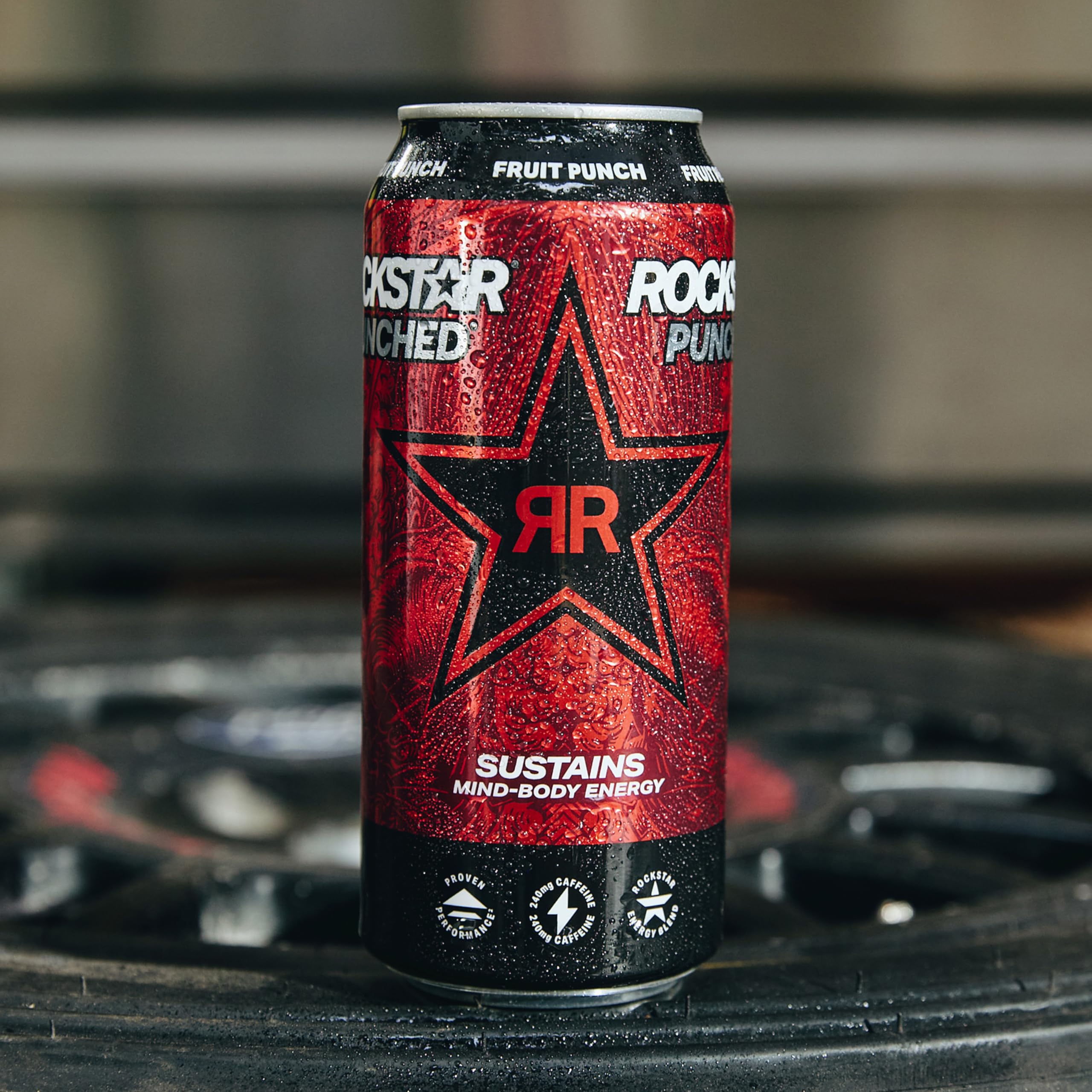 Rockstar can beside a hand for scale showing 16oz size and portability benefit