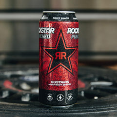 Rockstar can beside a hand for scale showing 16oz size and portability benefit