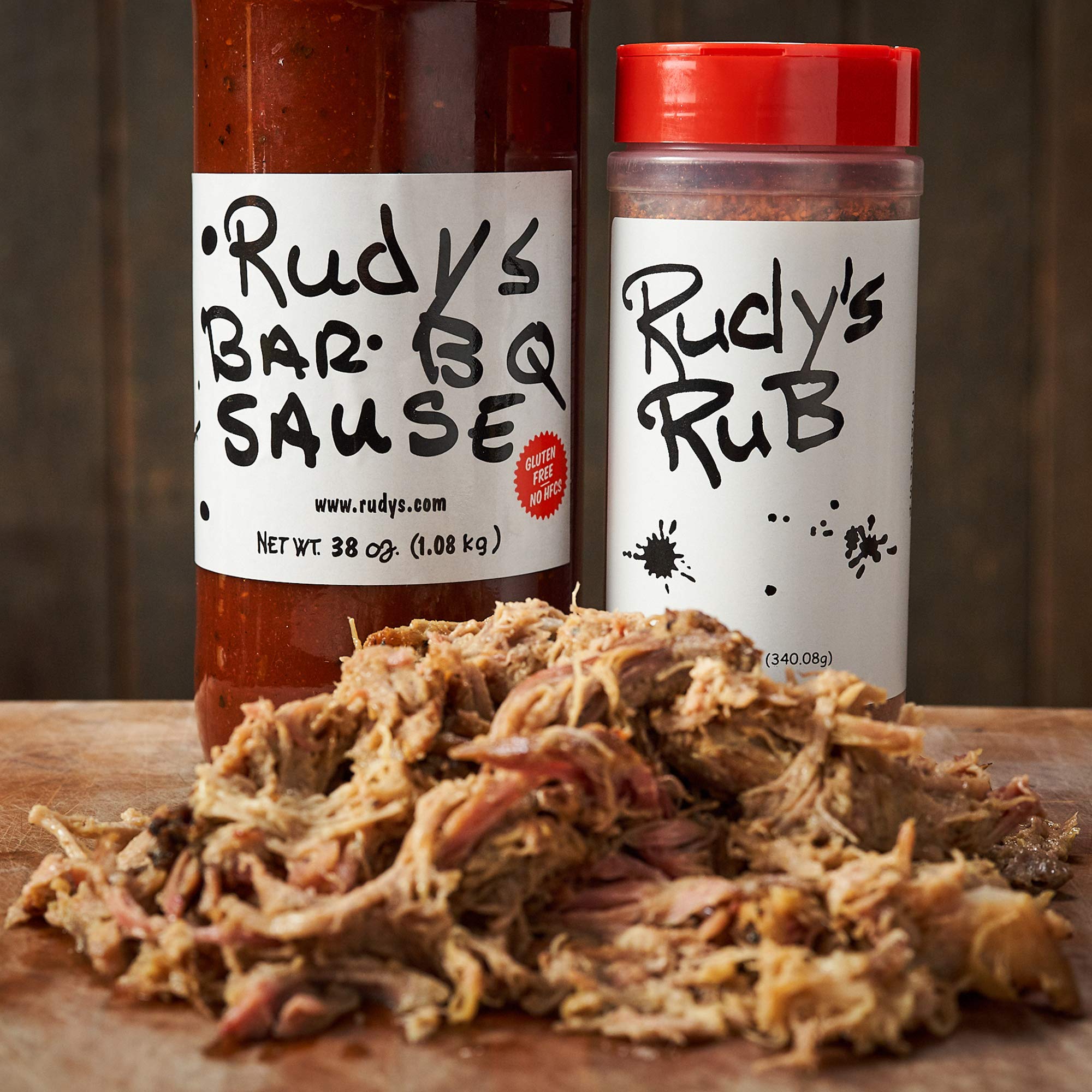 RUDY'S COUNTRY STORE AND BAR-B-Q bottle beside a backyard grill illustrating outdoor use