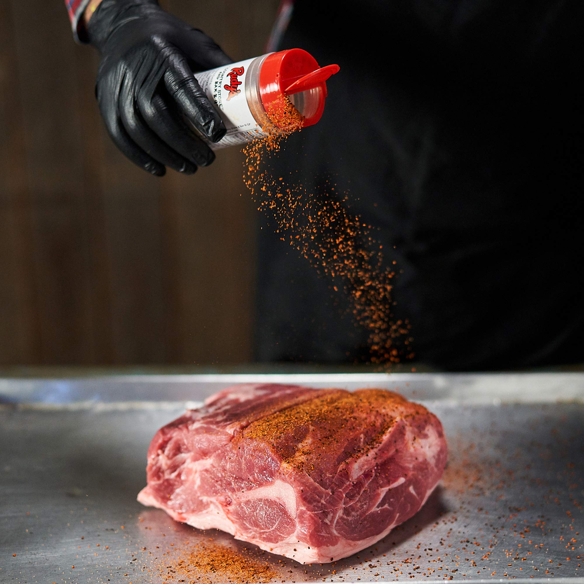 RUDY'S COUNTRY STORE AND BAR-B-Q bottle held by hand showing 12 ounce scale