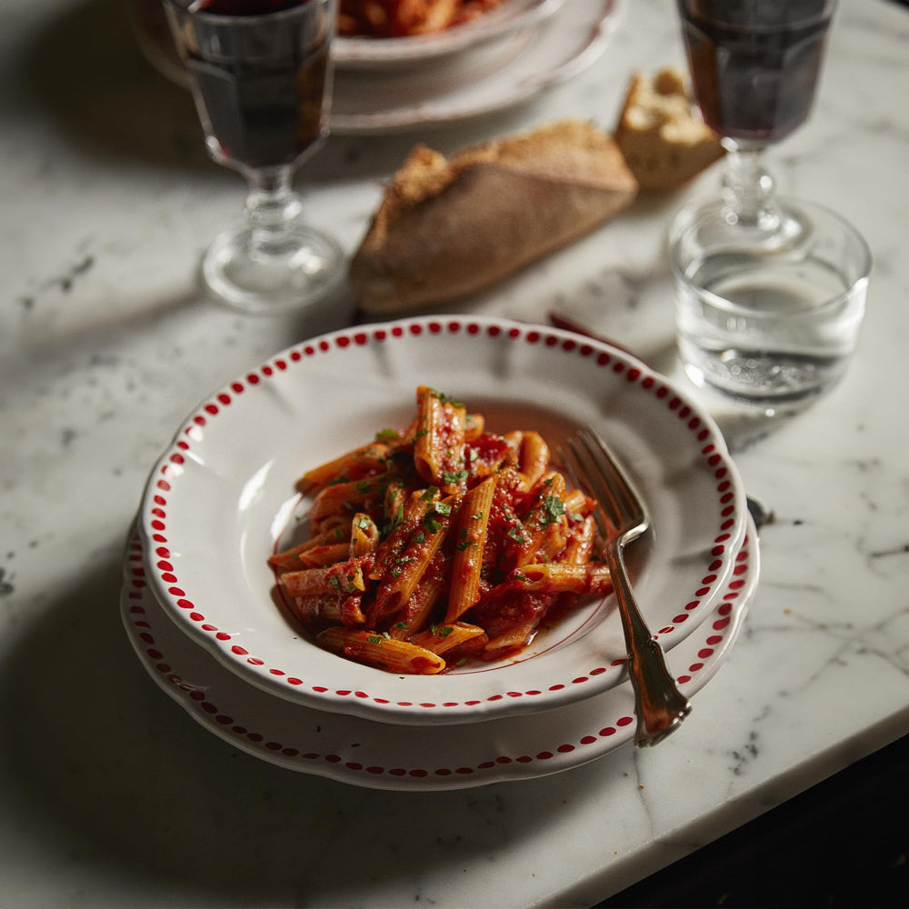 Rummo penne on a table set for dinner illustrating authentic Italian meal