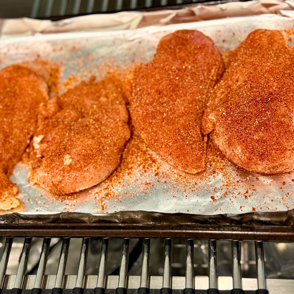 grilled chicken thighs seasoned with RunninWild peach rub for juicy flavor