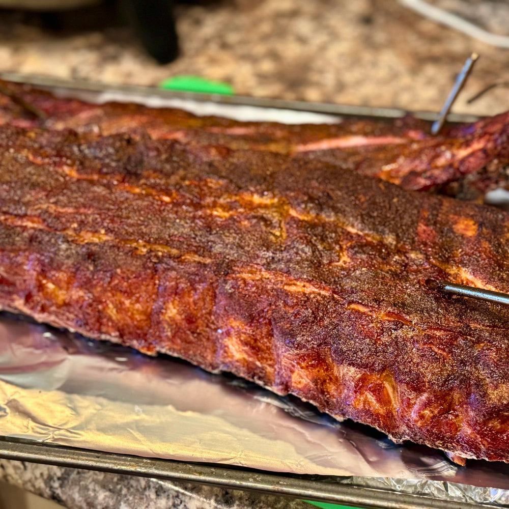ribs coated in RunninWild peach rub with glossy caramelized crust