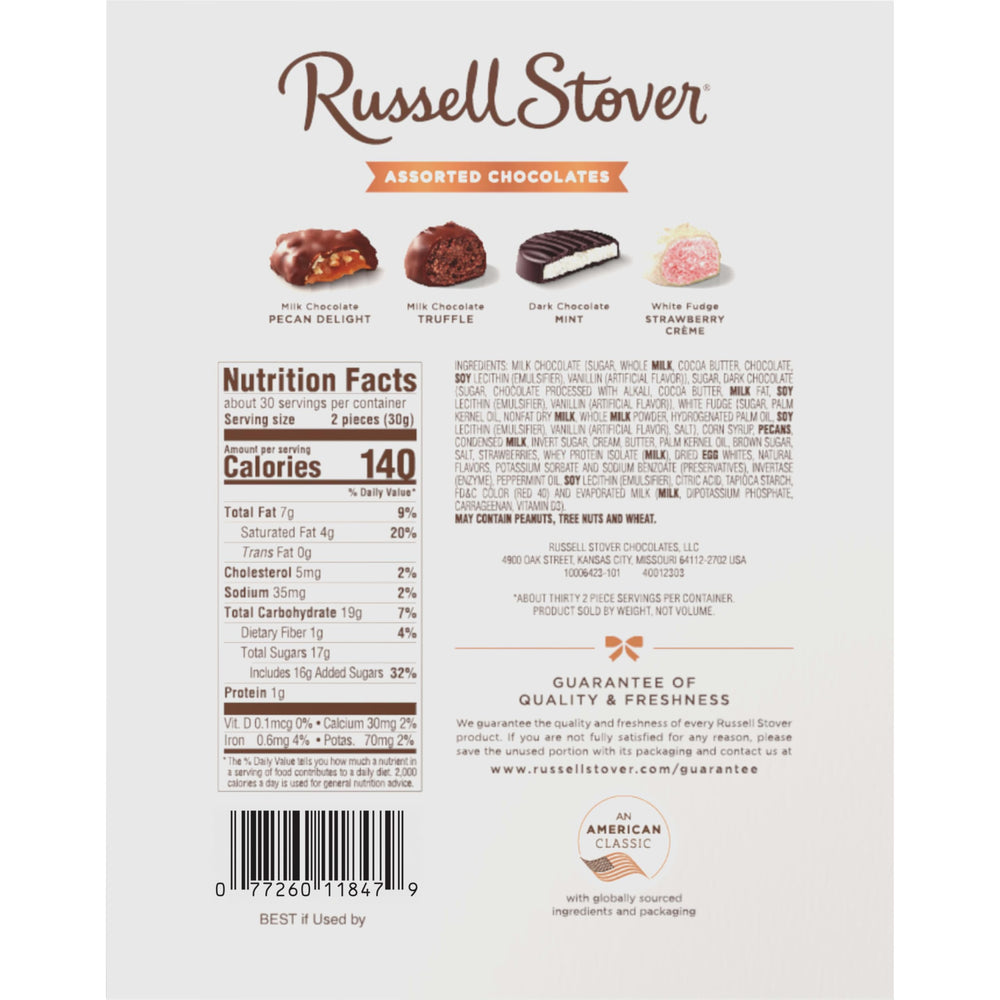 Russell Stover tin pictured next to common items for scale to show 32.1 oz size
