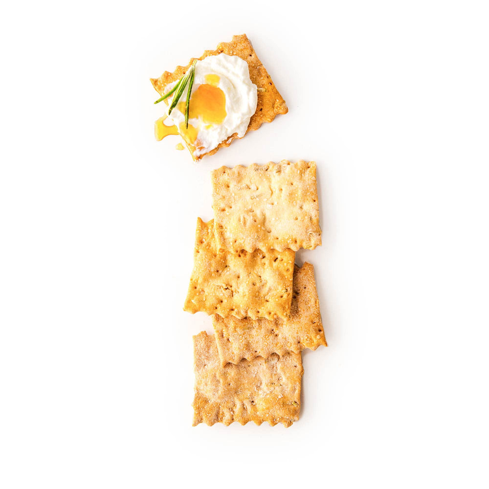 Rustic Bakery crackers on a cheese platter pairing with cheeses and meats