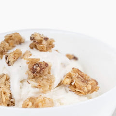 The Safe + Fair granola in a bowl with yogurt and berries for balanced breakfast