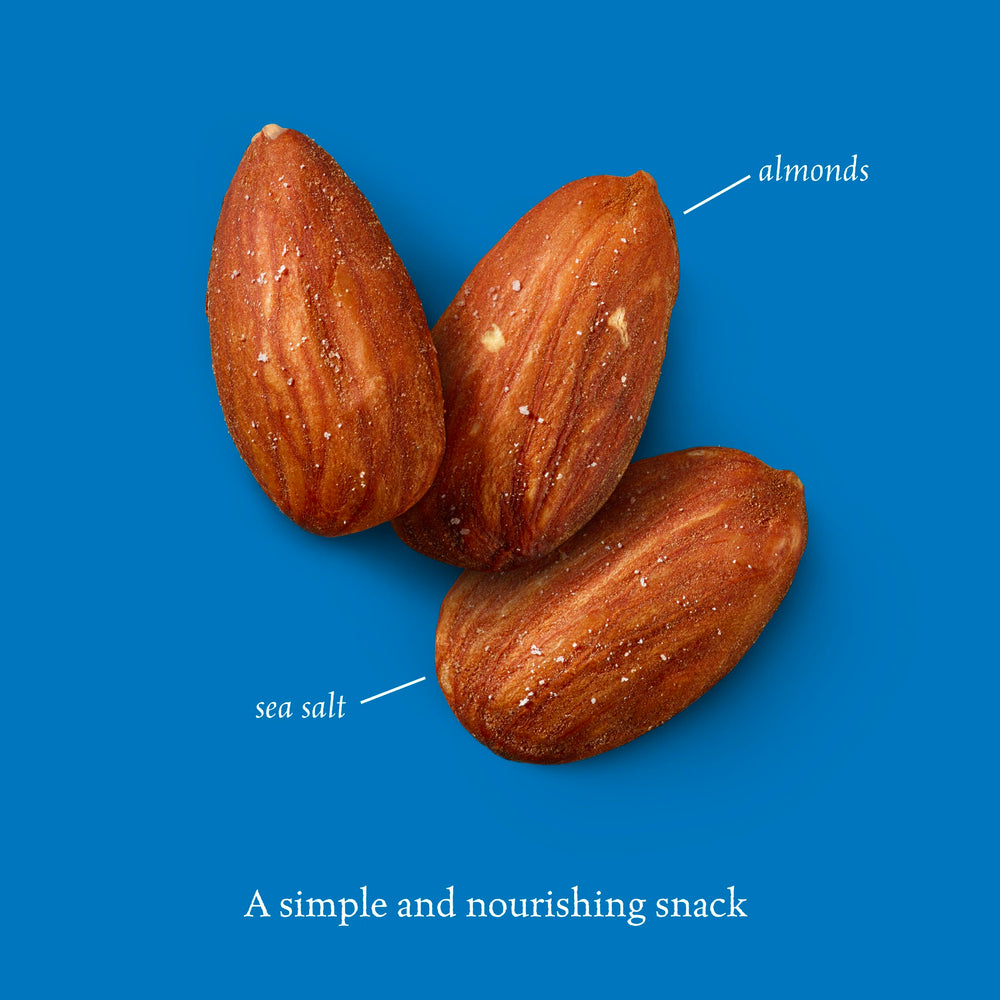 Sahale Snacks handful of almonds on wood table showing natural ingredients and attractive appearance