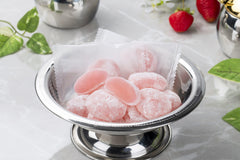 Sakura Box Seiki strawberry mochi on plate paired with tea for elegant serving