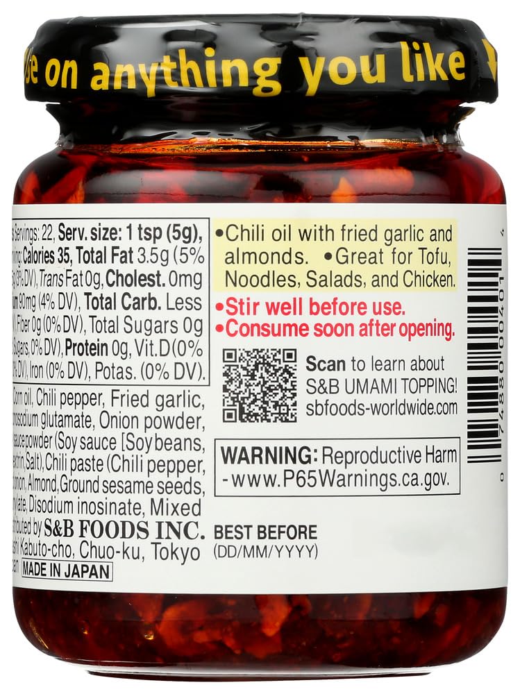 S&B chili oil on a spoon showing oil sheen and chili flakes for flavor