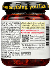 S&B chili oil on a spoon showing oil sheen and chili flakes for flavor