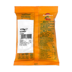 Sanniti candies in hand next to coin showing scale and portable convenience for on-the-go refreshment