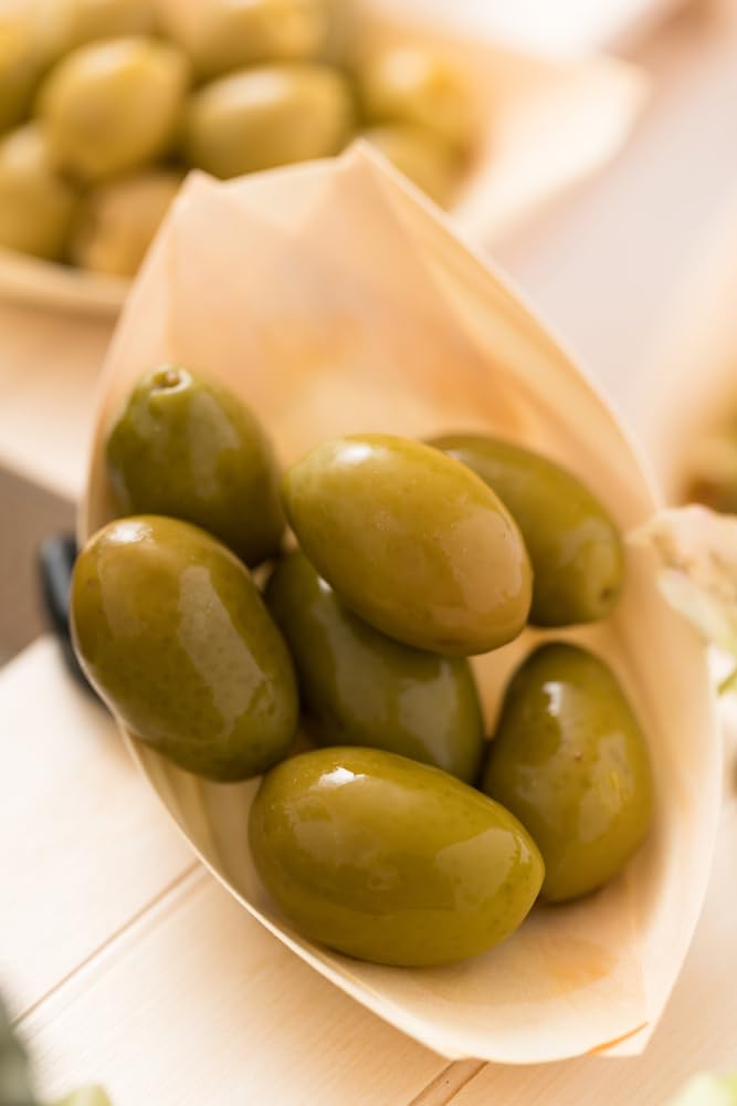 Sanniti olives tossed in salad bowl, adds savory Mediterranean flavor