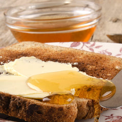 Sanniti Fulmer honey on spoon next to ruler, shows jar size and scale
