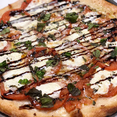 Thick glossy stream of Sanniti balsamic highlighting dense texture and concentrated flavor benefit