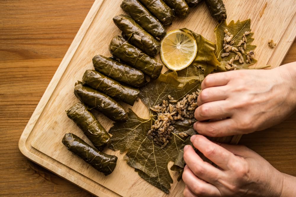 Sanniti leaves being rinsed under water for reduced salt and prep speed