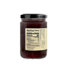 Sanniti open jar revealing whole lingonberries and glossy texture, easy spoon serving