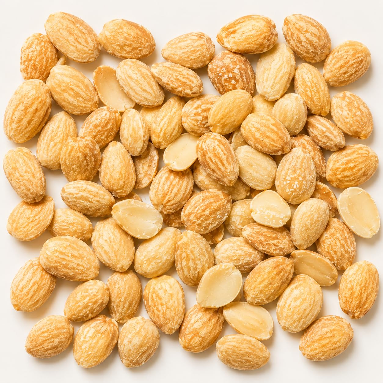 Sanniti almonds poured on white plate highlighting buttery crunch and ready-to-eat benefit