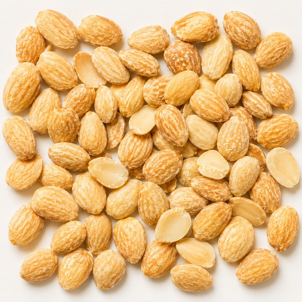 Sanniti almonds poured on white plate highlighting buttery crunch and ready-to-eat benefit