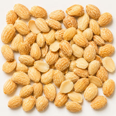 Sanniti almonds poured on white plate highlighting buttery crunch and ready-to-eat benefit