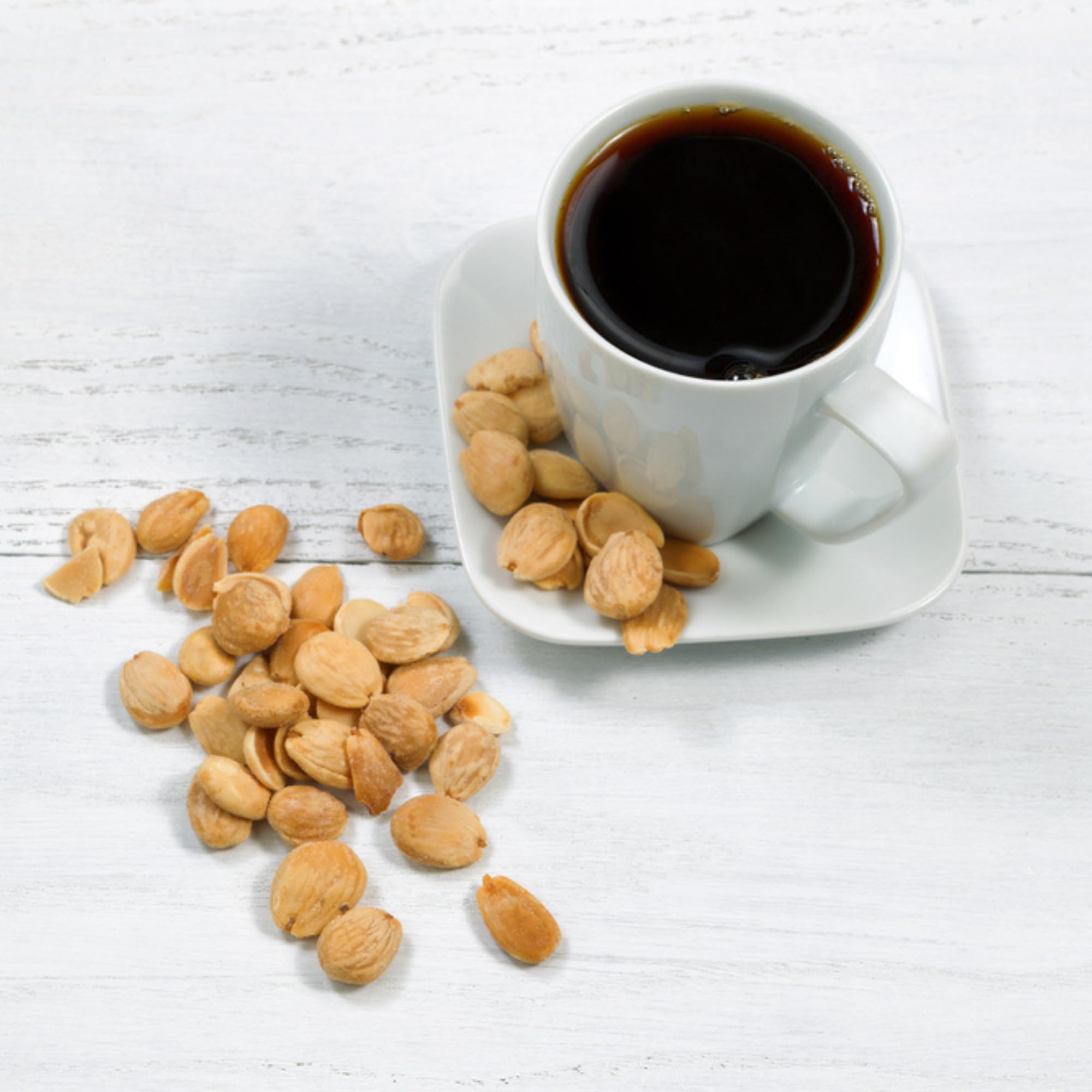 Hand holding Sanniti Marcona almonds to show size and tender texture benefit