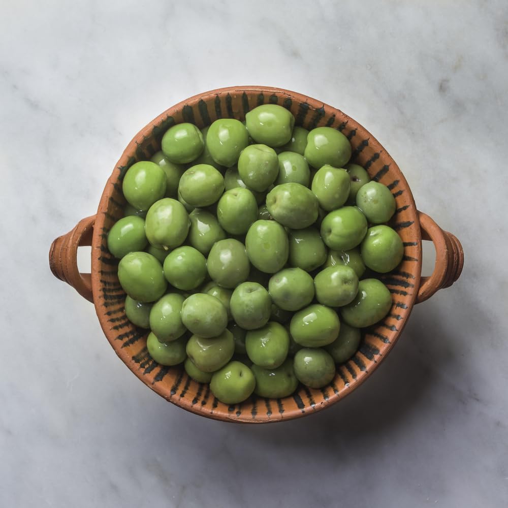Sanniti single olive on spoon showing glossy surface and easy serving
