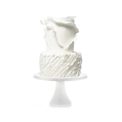 Satin Ice Tropical fondant being draped on a wedding cake for professional finish
