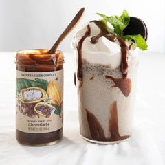 Savannah Bee Company spoon lifting whipped honey to show airy texture and spreadability