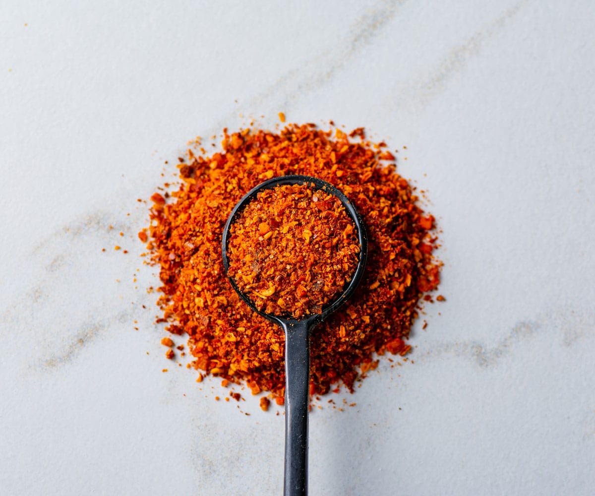 Savory Spice jar open revealing flaky merquen for easy seasoning