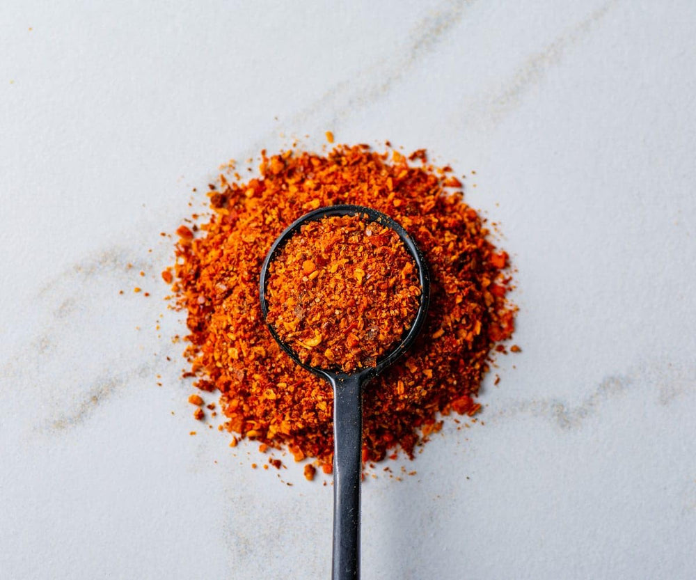 Savory Spice jar open revealing flaky merquen for easy seasoning