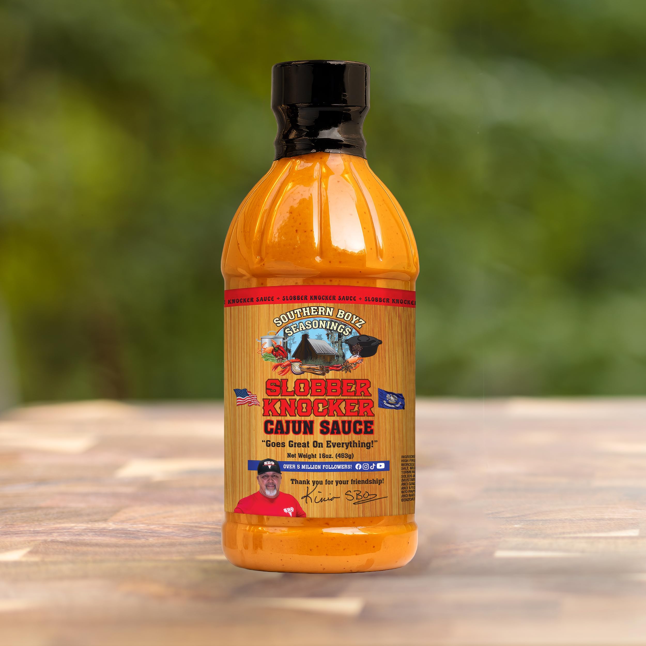 SBO Southern Boyz sauce pouring from bottle over grilled chicken for added flavor