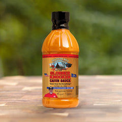 SBO Southern Boyz sauce pouring from bottle over grilled chicken for added flavor
